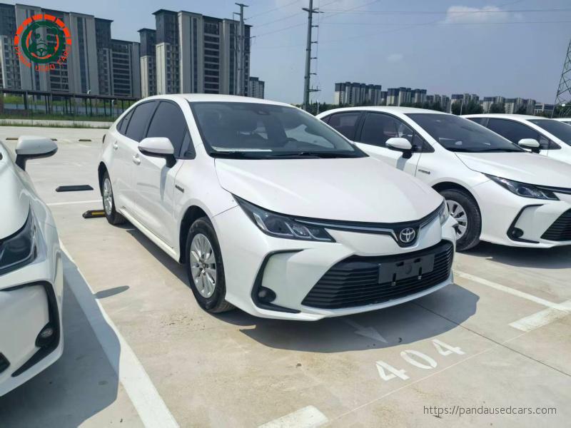 Rear view of a white 2021 Toyota Corolla Hybrid sedan